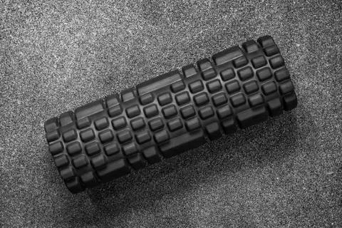Massage roller lying on floor Stock Photos
