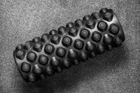 Massage roller lying on floor Stock Photos