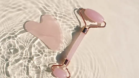 Massage roller on water with drops on a beige background. Pure water with Stock-Footage 201344202