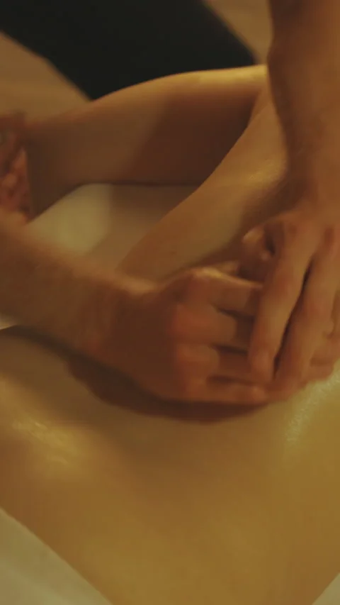 Massage session - massaging oily bare back of a woman Stock Footage 328400425