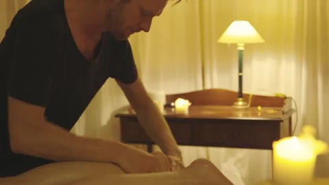 Massage session - the master massages the foot of his client Stock Footage 243135540