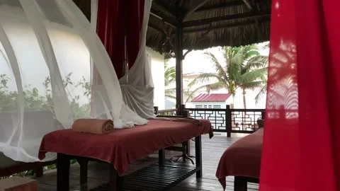 Massage table among palm trees, near the sea Stock Footage 122842969