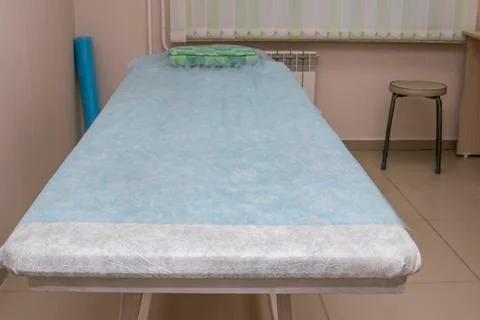 Massage table in the office of the masseur. Stock Photos