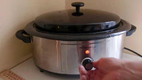 The massage therapist turns the temperature controller on the stone heaters Stock Footage 81097136