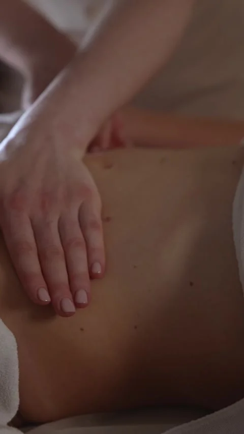 Massage therapy session in a wellness center focusing on relaxation and muscle Stock Footage 341281841