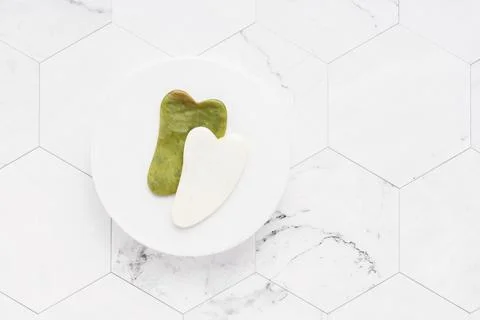 Massage tools. Two Gua Sha massages on a white marble background. SPA concept Stock Photos