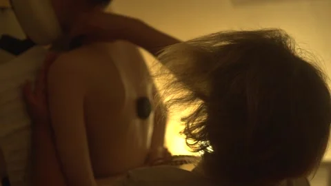 Massage of a young woman's back with hot stones Stock Footage 305647166