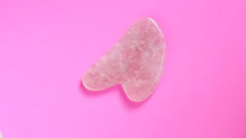 The massager gua sha on pink background, top view Stock Footage 150534304