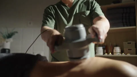 Massages a man's back in his SPA salon. Stock Footage 248349249