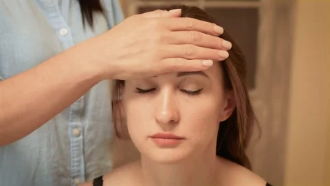 Massaging forehead using gentle hand movements. Stroking forehead promoting Stock Footage 301992535