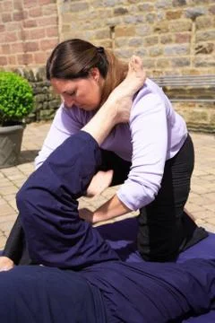 Massaging the hamstring Stock Photos
