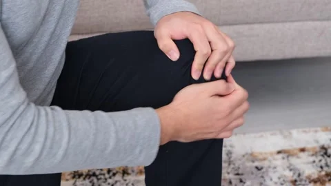 Massaging his knee Stock Footage 264776367