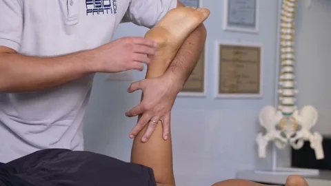  massaging  with pressure the back of a patient- physiotherapy session Stock Footage 82723375