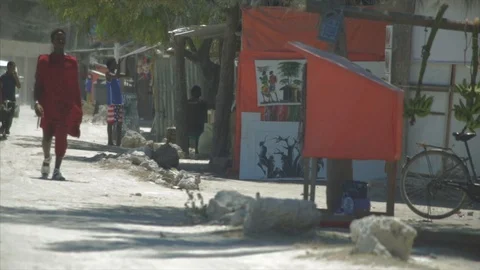 A Massai man walks down the streets of Zanzibar. Stock Footage 86648133