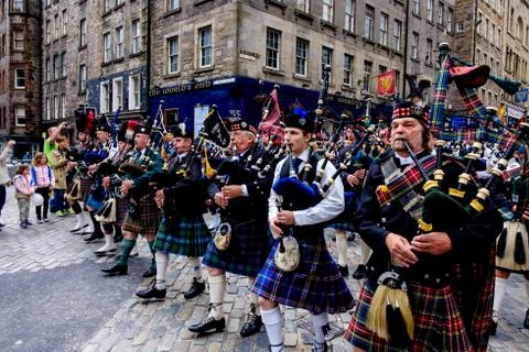 Massed Pipe Bands march down the Royal Mile in Edinburgh during the festival Stock Photos