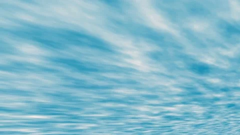 Masses of elongated clouds floating from left to right across the blue sky. Stock Footage 234769725