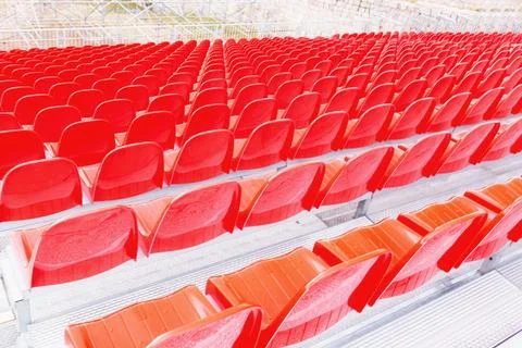 Masses of empty plastic red chairs or seats in a school assembly hall Stock Photos