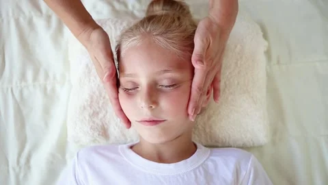 Masseur doing face massage to child. Stock Footage 158794716