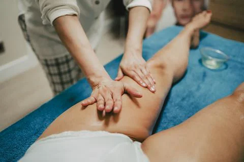 Masseur doing a lymphatic drainage to a client in a beauty center Fotos de archivo