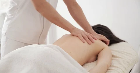 Masseur doing relaxing, invigorating back massage young girl at Spa salon Stock Footage 125622056