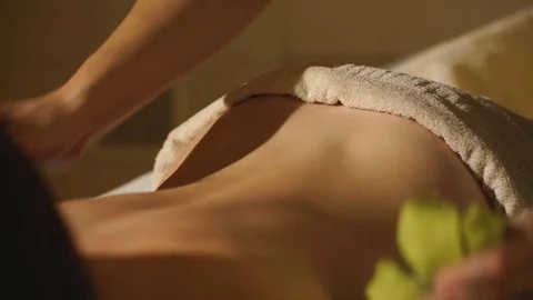 Masseuse doing Thai massage with salt bags Stock Footage 70357772