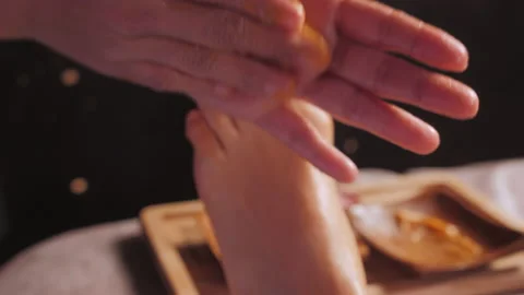 Masseuse hands apply organic mango scrub on woman leg Stock Footage 195419224