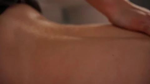 Masseuse's hand slips over a woman's back Stock Footage 306269876