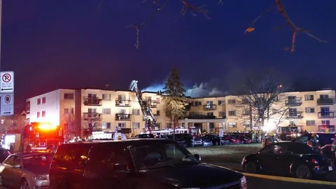 Massive apartment bloc on working fire at night Stock Footage 114648622