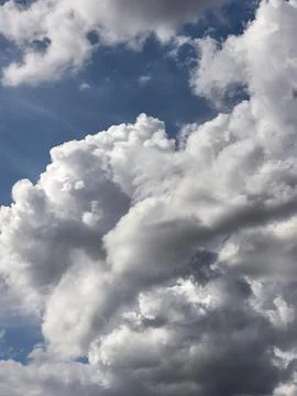Massive Billowing Cumulus Clouds Filling Dramatic Blue Sky Stock Photos