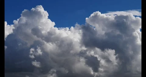 Massive Billowing White Cumulus Clouds In Blue Sky Real Shot Vídeo Stock 332717733
