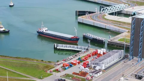 Massive blue drawbridge stands tall allow cargo ship enter inland canal network Stock Footage 327650586