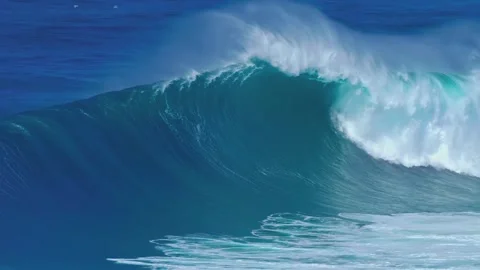 Massive blue ocean wave cresting during powerful storm swell captured in dynamic Stock Footage 345482758