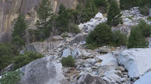 Massive Boulders Against Mountain Wall with Vehicle for Size Reference in Stock Footage 312686466