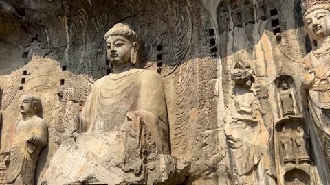 Massive Buddhist statues in Fengxian Temple Cave at Longmen Grottoes Stock Footage 324716640
