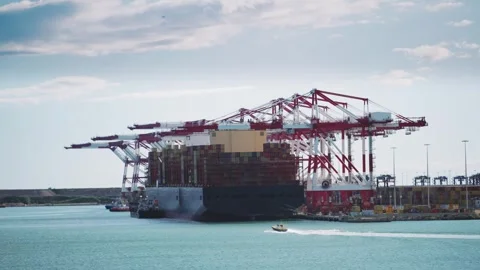 Massive Cargo Ship Unloading Containers at Bustling Port Stock Footage 332483952