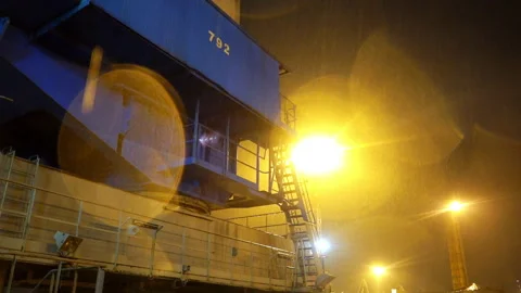 Massive cargo vessel stands motionless in rainy harbor Stock Footage 320434796