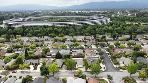 Massive circular tech campus building rises beyond suburban neighborhood Stock Footage 337746400