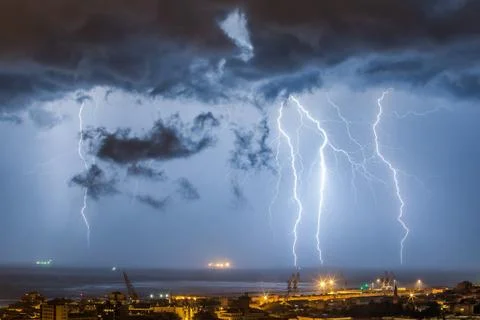 Massive cloud to ground lightning bolts hitting Stock Photos