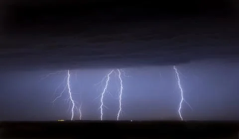 Massive cloud to ground lightning bolts hitting Stock Photos