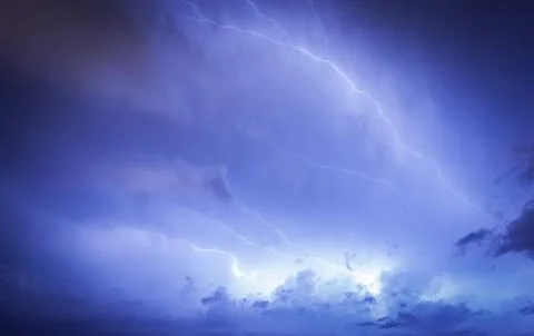 Massive cloud to ground lightning bolts hitting Stock Photos