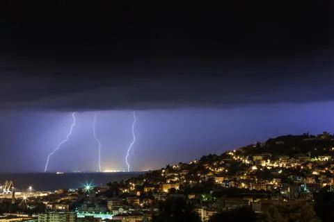 Massive cloud to ground lightning bolts hitting Stock Photos
