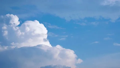Massive clouds - cumulus congestus or towering cumulus - forming in the blue sky Stock Footage 137425281