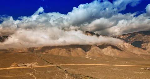 Massive cloudscape coating the tops of the mountains in Death Valley.  Stock Footage 250438322