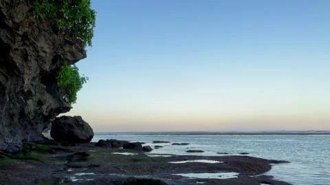 Massive Coastal Cliff and Calm Ocean Tide Pools in Bali Stock Footage 337336695