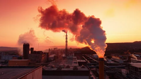 A massive column of thick smoke coming directly from a central industrial stack. 動画素材 345614950