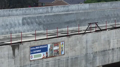 Massive concrete high-speed rail viaduct under construction with a California Stock Footage 337669994
