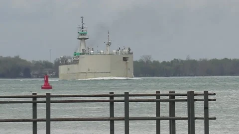 Massive container and cargo ship heading up river to oil refinery in Sarnia Stock Footage 153829095