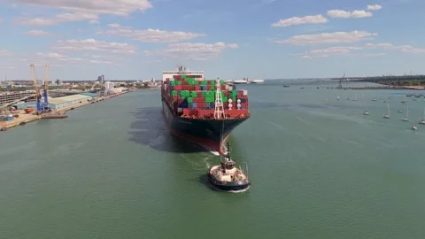 A massive container ship moves through the water at the Port of Southampton Vídeos de archivo 346881379