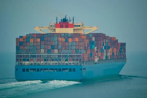 Massive Container Ship Navigating Calm Open Waters with Colorful Cargo Stock Photos