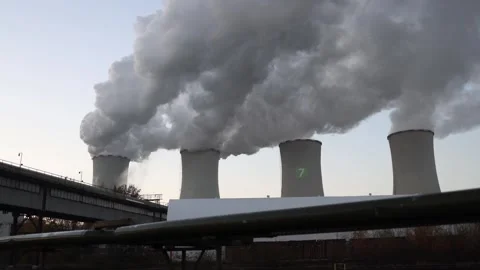 Massive cooling towers release thick gray steam into the pale evening sky  Stock Footage 321650808